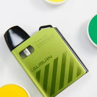 Green Uwell Caliburn AK2 15W Pod System with sleek diagonal stripes, compact vape with Type-C charging and 0.9ohm coil.