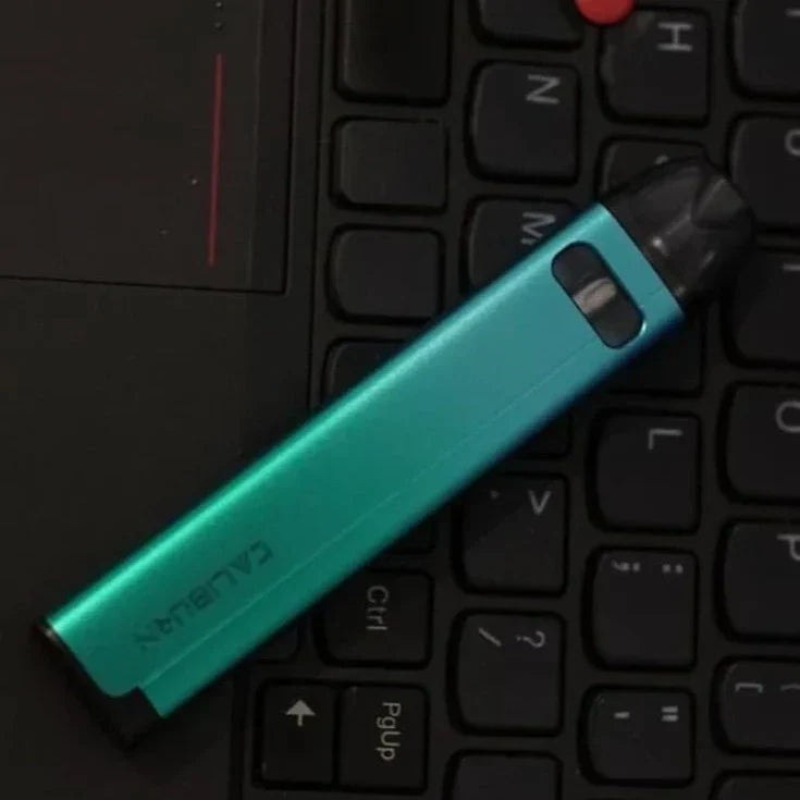 Uwell Caliburn A2S Pod System - 520mAh, 2mL pod in teal color placed on a black laptop keyboard, showcasing its sleek and compact design.