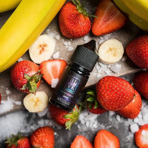 BLVK Nicotine Salt E-Liquid - 30ML surrounded by fresh bananas and strawberries, highlighting fruity vape flavor appeal in a lifestyle setting.