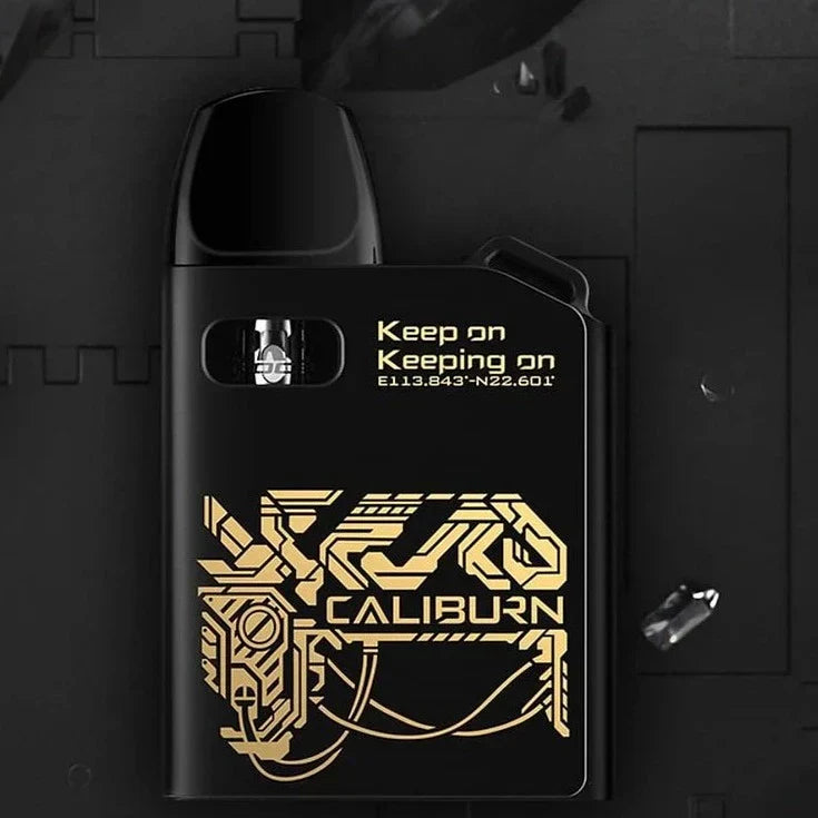 Black Uwell Caliburn AK2 15W Pod System with gold circuit design, featuring 2mL pod and 520mAh battery for portable vaping.